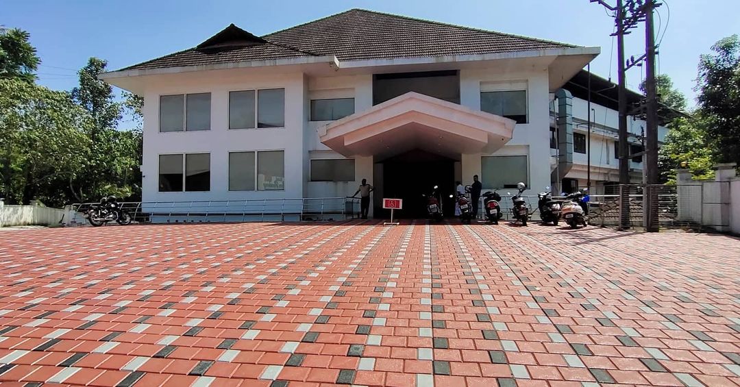 Hamerkop construction – modern multi-story building with paved forecourt, Tanzania